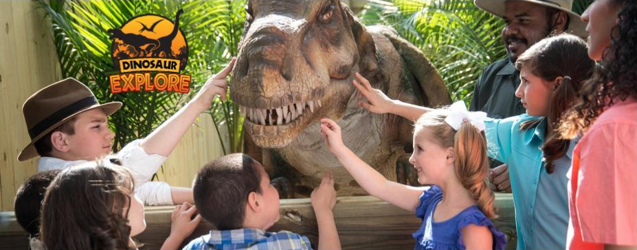 Kids touching a dinosaur at Dinosaur Explore at Wild Adventures